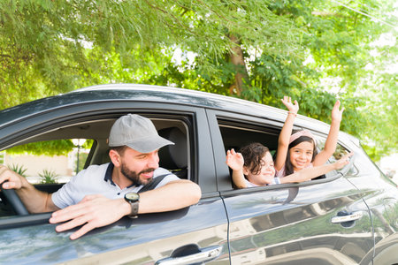 Cute children laughing and having fun while putting their heads out of the car window. Beautiful...