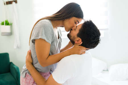 Attractive young couple in love kissing and making out with passion. Loving boyfriend and girlfriend...