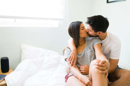 Latin young couple in love kissing and giving each other love. Gorgeous girlfriend and boyfriend...