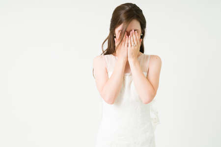 He stood me up. Sad caucasian bride in a white dress crying and feeling heartbroken on her wedding ceremonyの写真素材