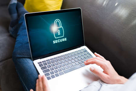 Cybersecurity and encryption. Person installing a data protection program on the laptopの写真素材