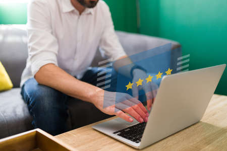 I love quality products. Young man typing a review for a product or online service