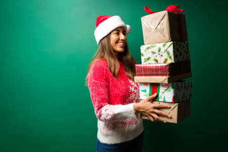 Gorgeous young woman got her family and friends a lot of christmas presentsの写真素材