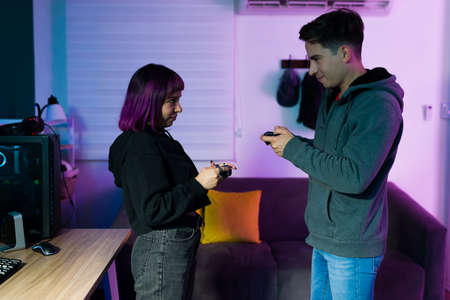 Video game competition. Young friends face to face and starting a match while playing video gamesの写真素材