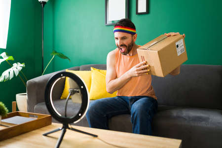 Unboxing video. Excited trans person showing a new package to her subscribers while filming a video...
