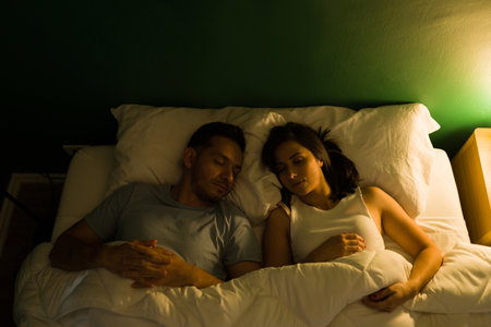 We love spending the night together. Top view of an hispanic couple sleeping on a comfy bedの写真素材