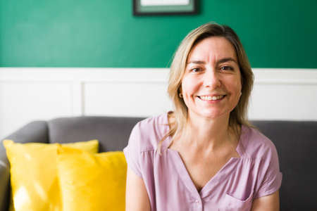 I have a full life. Portrait of a mature woman in her 50s looking at the camera and smilingの写真素材