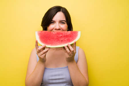 Happy woman with a big smile of watermelon. Caucasian woman eating delicious red watermelonの写真素材