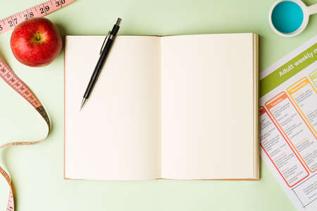 Food diary. Notebook and planner to write diets, calories and healthy recipes. Going to the...