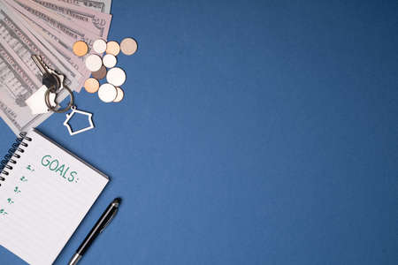 Finance goals and savings. Notebook with a personal finance plan and mortgage paymentsの写真素材