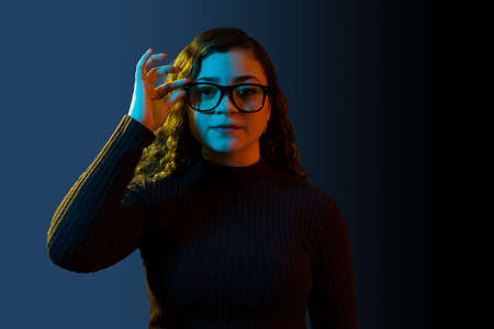 Immersive technology. Portrait of a caucasian young woman using high tech glasses to watch an...