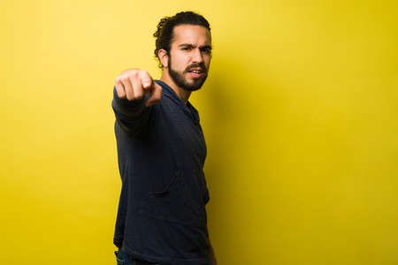 You are responsible. Angry young man pointing ahead and blaming you for the problems