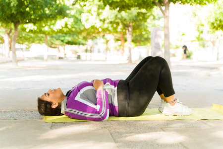 I'm so tired of diets. Tired fat young woman taking a break and resting after a hard workout to lose...