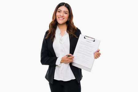 Cheerful young attorney signing a new business contract and feeling happy. Portrait of a female lawyer smiling to a clientの写真素材