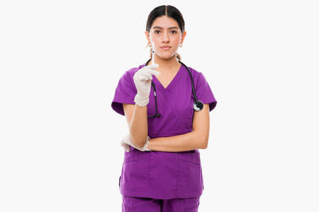 Smart medical nurse wearing purple scrubs and holding a syringe to give a medicine shot to a patientの写真素材