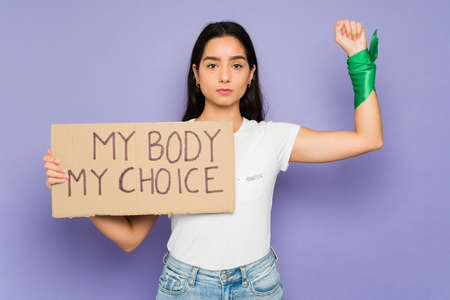 My body my choice message. Pro choice young woman asking to legalize abortion during a feminist protestの写真素材