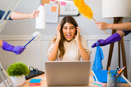 Stressed woman with a lot of work feeling overwhelmed and screaming because of all the housework...