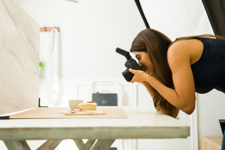 Profile of a happy photographer doing a food photo shoot at her professional studio