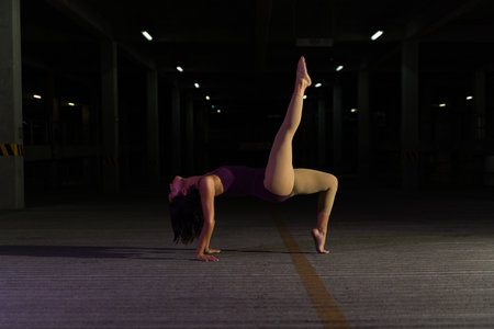 Side view of a female ballet dancer wearing a leotard and dancing during an artistic performance on...