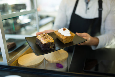 Close up of a male worker with the delicious dessert order at the coffee shop or cafe