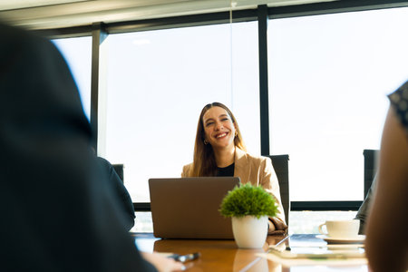 Beautiful Caucasian businesswoman being friendly and smiling while participating in a business meetingの写真素材