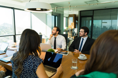 Attractive man participating in a discussion and sharing his opinion in a business meetingの写真素材
