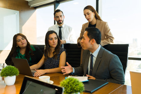 Group of attorneys and businesspeople gathered together and discussing an important topic