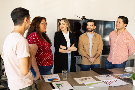 Diverse group of businesspeople dressed casual and relaxing together in the office