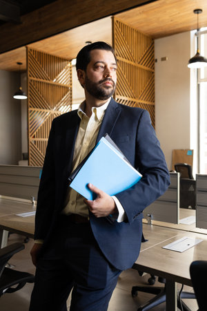 Portrait of a Latin laywer carrying some contracts in hand and waiting for a meeting to startの写真素材