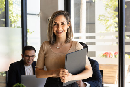 Happy businesswoman ready to do some business while standing in a meeting room