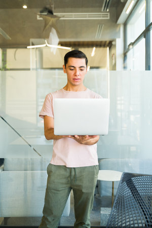 Caucasian businessman with casual look using a laptop computer in a meeting room