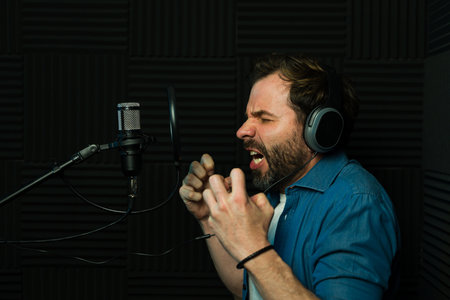 Caucasian voice actor screaming and portraying an angry character during a voice recordingの写真素材