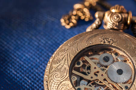 Pocket watch on blue tableの写真素材