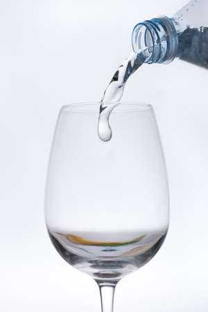 Water bottle, pouring its contents into a glass cupの写真素材