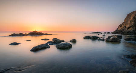 Rocks bathed by the calm seaの写真素材