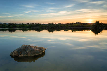 Dawn in the city of Almeria, where at the mouth of its main river, a large amount of water stagnates giving rise to a natural lake.の写真素材