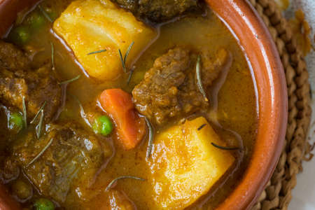 Typical Spanish food, composed mostly of potatoes, peas, carrots, meat, artichoke, etc ...の写真素材