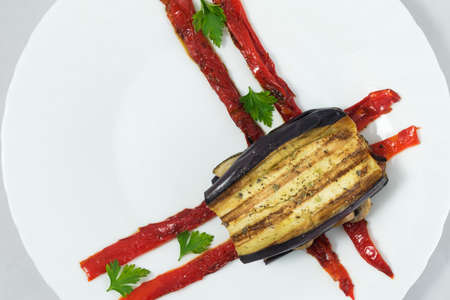 Delicious plate of eggplant, sandwich style, in its interior highlights a portion of mushrooms, zucchini, peppers and aubergine.の写真素材