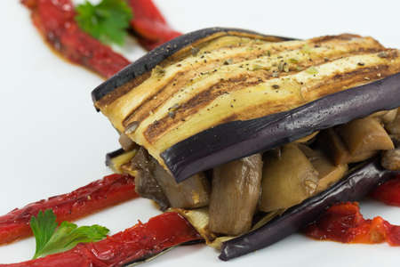 Delicious plate of eggplant, sandwich style, in its interior highlights a portion of mushrooms, zucchini, peppers and aubergine.の写真素材