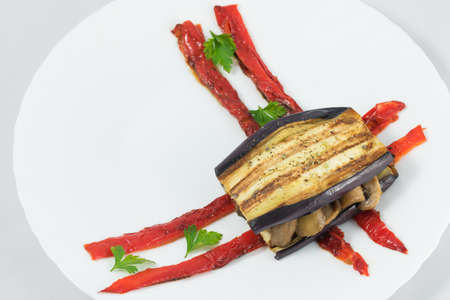 Delicious plate of eggplant, sandwich style, in its interior highlights a portion of mushrooms, zucchini, peppers and aubergine.の写真素材