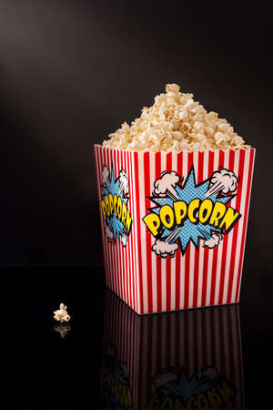 Popcorn inside a red and white striped bowlの写真素材