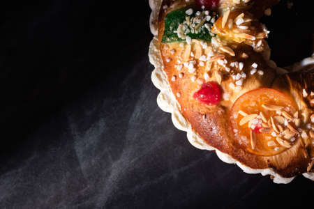 Roscon de Reyes traditional from Spain, which are taken by Spanish families every January 6. Roscon de reyes on black background.の写真素材