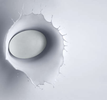 Bar of soap fallen into milk with splashの写真素材