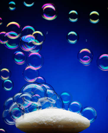 bar of soap with bubbles on blue backgroundの写真素材