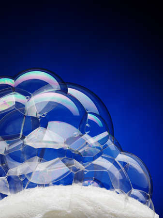 bar of soap with bubbles on blue background