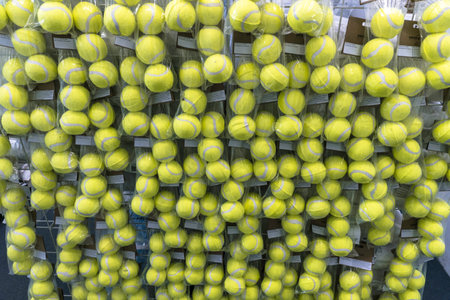 Tennis balls in plastic cups on rackets at the sports store