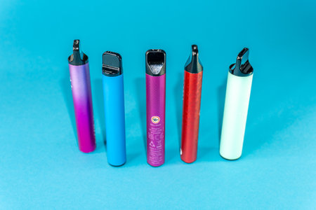 Lighters on a blue background. The concept of the electronic cigarette industry.の写真素材