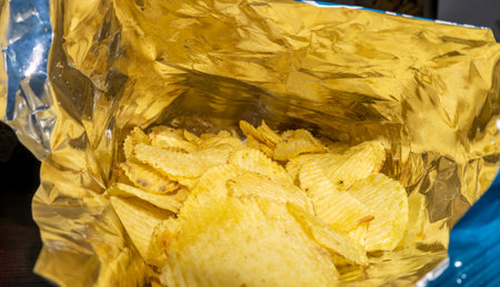 Crispy potato chips in plastic bag. Close-up.
