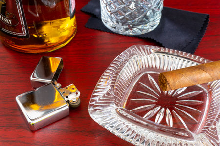 Cigar, glass ashtray and cigar on the table