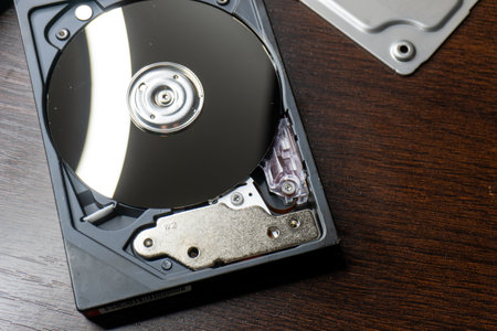 Hard disk drive on wooden background. Close up. Selective focus.